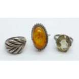 A Russian silver and amber ring, size N, and two other silver rings, (size M, shank a/f and stone