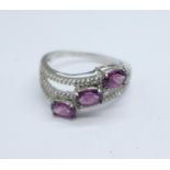 A 9ct gold, magenta garnet and white sapphire ring, 3.4g, S
