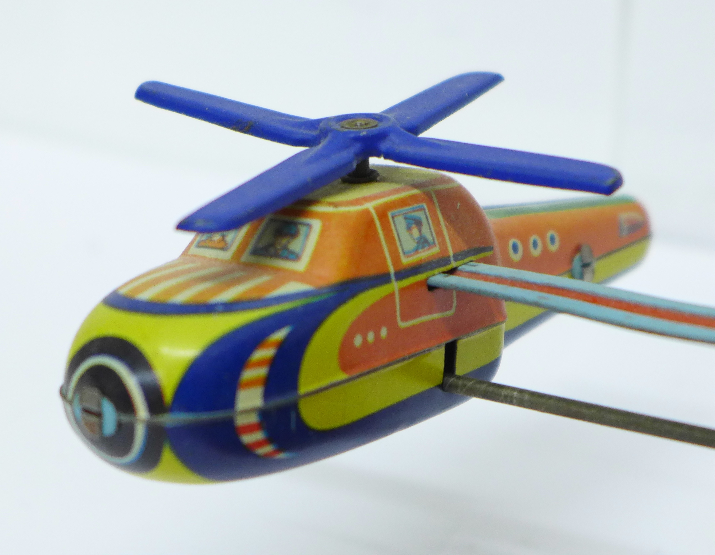 A tin-plate clockwork helicopter toy, made in Western Germany, and one other tin-plate clockwork toy - Image 2 of 4