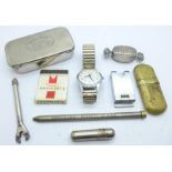 A silver pill box in the form of a wrapped sweet, a Sekonda wristwatch, a lighter, a magnifying