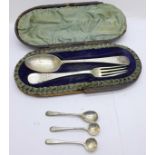A Victorian silver fork and spoon christening set, cased, and a set of three silver condiment
