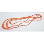 A coral coloured bead necklace