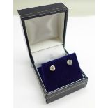 A pair of 18ct white gold and diamond stud earrings, total diamond weight 0.77carats