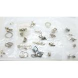 Twenty-five pairs of silver earrings