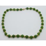 A jade and yellow metal necklace, the fastener marked 585, 41cm