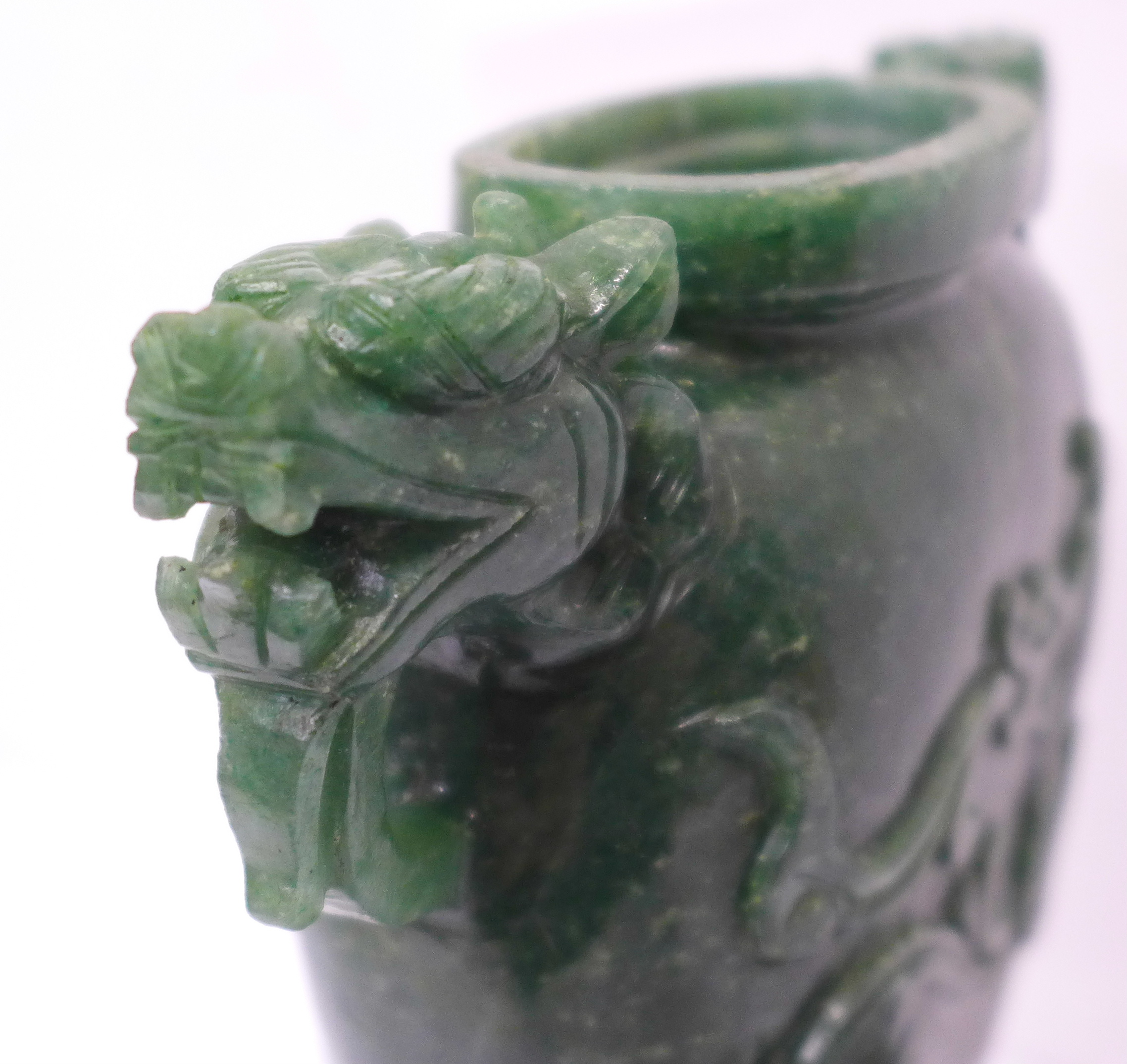 A carved green stone urn with lid, small losses to the lid and one ring missing, 23cm - Image 5 of 6