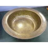 A large Eastern brass bowl with emblems, 47cm
