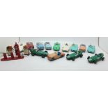 Thirteen Dinky die-cast vehicles and four petrol pumps