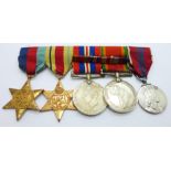 A set of four WWII medals including Africa Service Medal and a Queen Elizabeth II Coronation medal