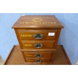 An early 20th Century walnut four drawer counter top haberdashery shop cabinet, bearing J&P Coates