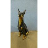 A painted pottery figure of a Doberman