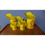 A set of five graduated Shell advertising jugs