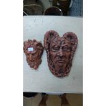 Two painted concrete wall masks