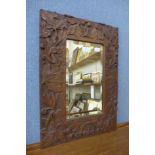 A carved oak rectangular framed mirror, 54cms x 39cms