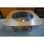 A simulated teak and glass topped coffee table