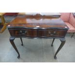 A mahogany two drawer serpentine side table