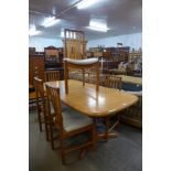 A teak extending dining table and six chairs