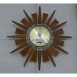 An Astey & Wilson teak sunburst wall clock