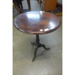 A mahogany and oak circular tripod table