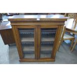 A Victorian walnut two door bookcase, 106cms h, 89cms w, 29cms d