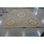 A large Chinese mint green ground rug, 385 x 279cms