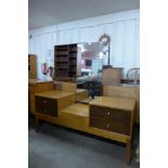 A Uniflex teak and afromosia dressing table and pair of matching bedside cupboards