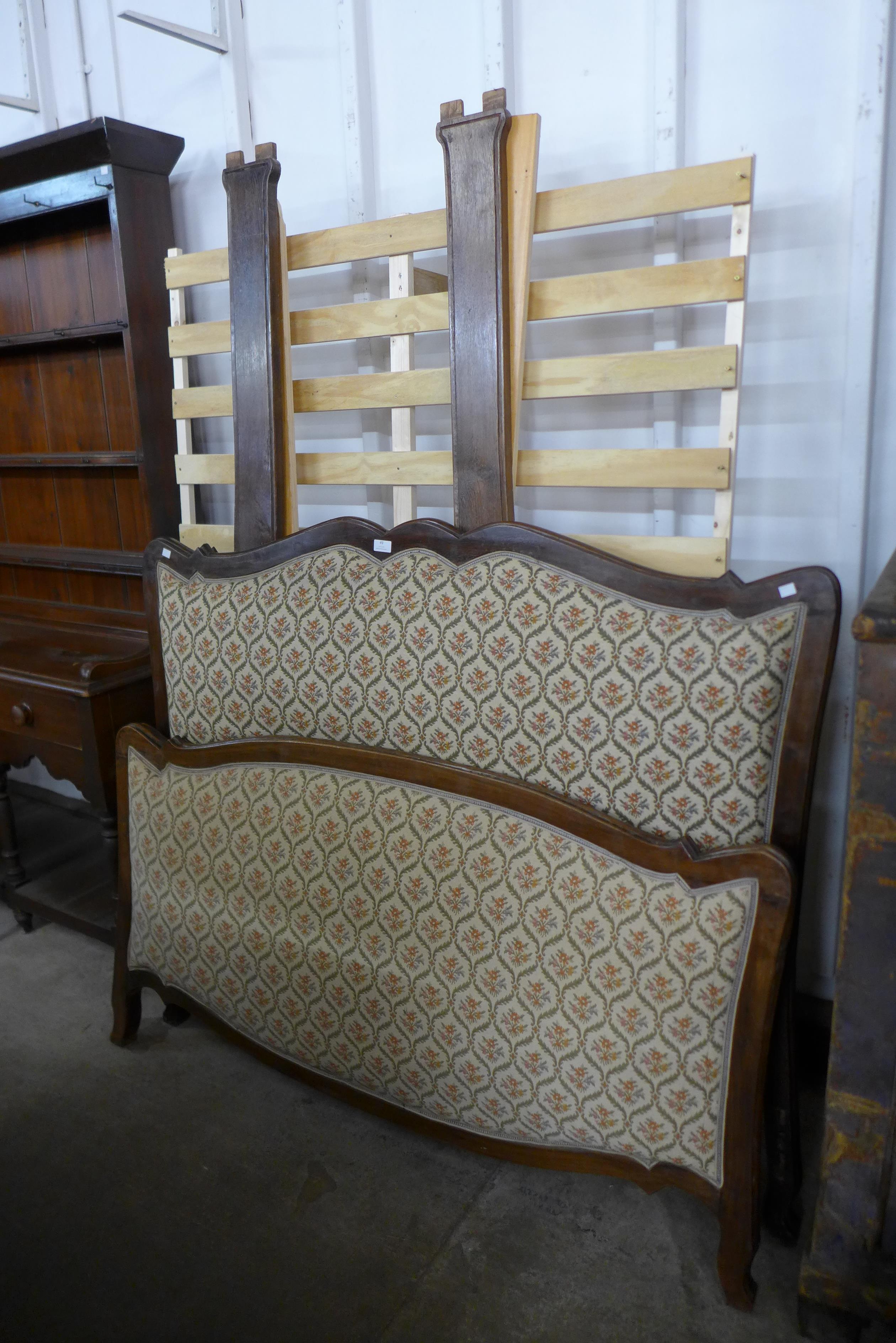 A French beech and upholstered double bed