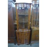 A yew wood serpentine freestanding corner cabinet and one other