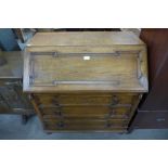 A carved oak bureau