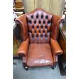 A red leather Chesterfield wingback armchair