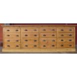 A large pine sixteen drawer cabinet, 91cms h, 260cms w, 36cms d