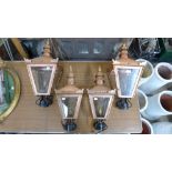 A set of four copper effect lantern lights