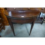 A George III inlaid mahogany demi-lune fold over card table, 74cms h x 92cms w