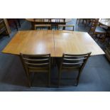 A McIntosh teak extending dining table and four teak dining chairs