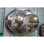 An Art Deco burnished steel oval mirror