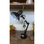 A black metal anglepoise desk lamp