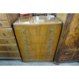 A walnut bow front chest of drawers