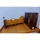 An Arts and Crafts oak book trough and a hardwood and brass mounted book shaped folio box