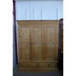 A pine three door wardrobe