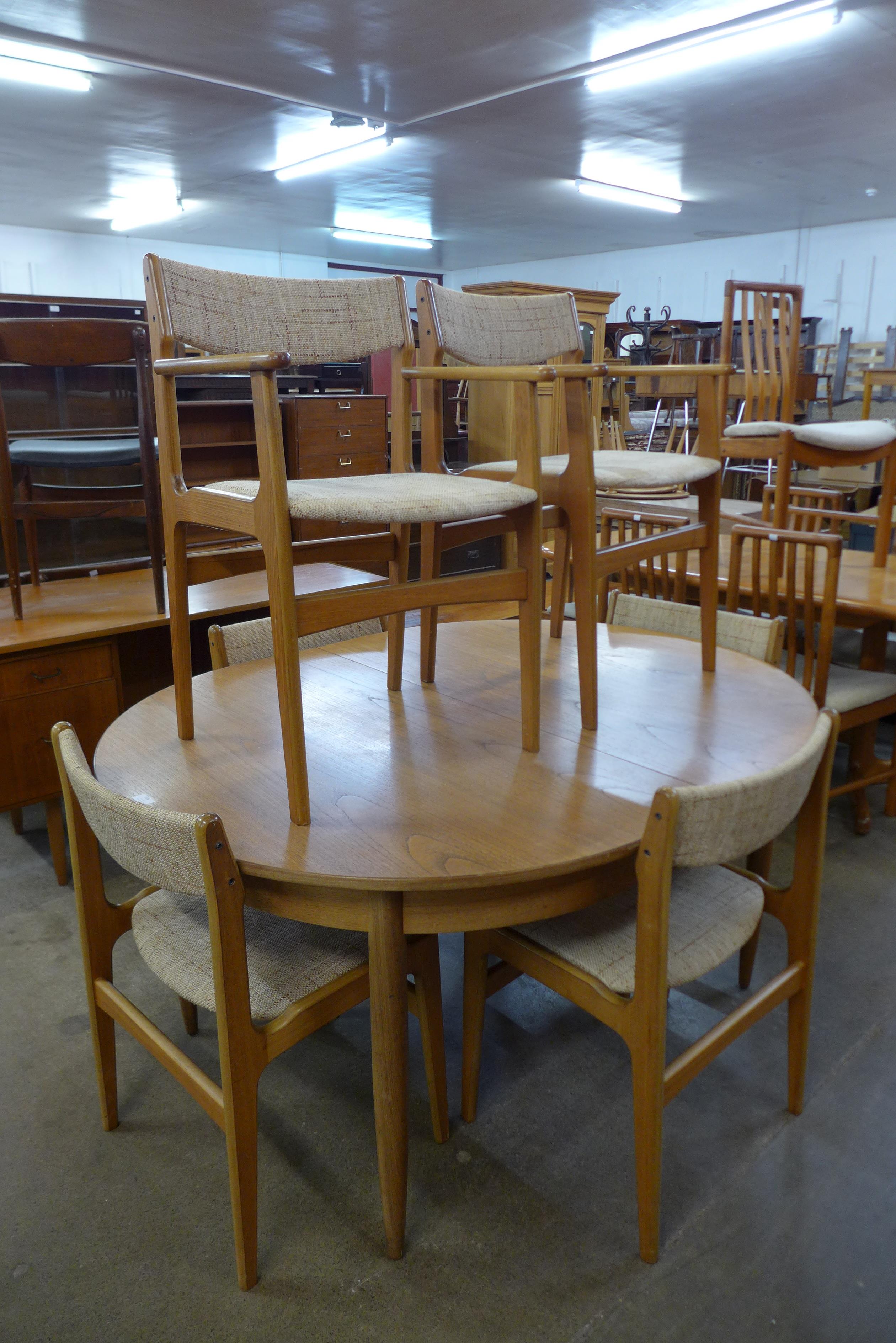 A teak extending dining table and six Eric Buch dining chairs
