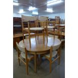 A teak extending dining table and six Eric Buch dining chairs