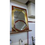 A pine mirror, a gilt framed mirror and an oval mahogany mirror