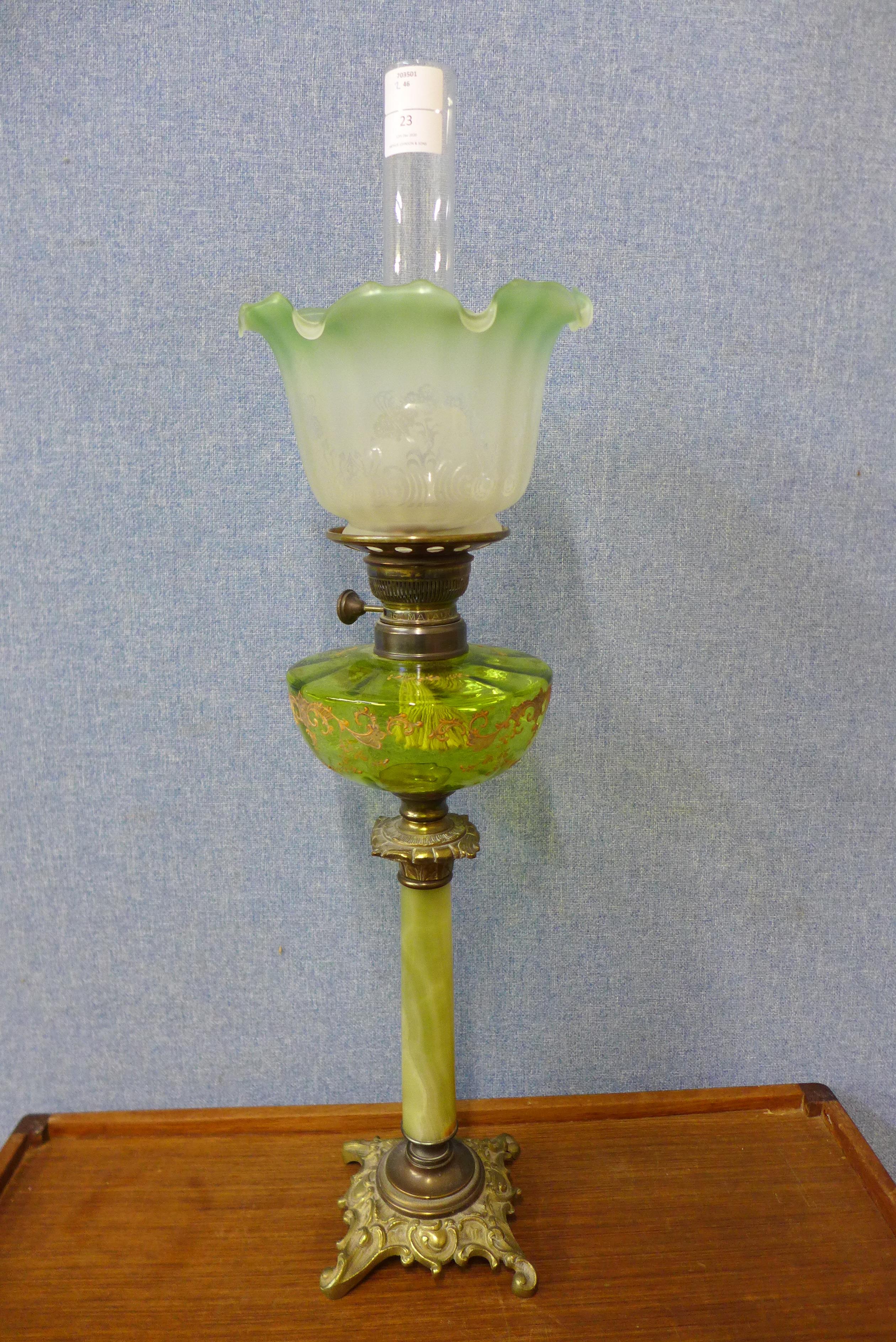 A Victorian Matador Brenner onyx and gilt metal oil lamp, with green glass reservoir, 76cms h