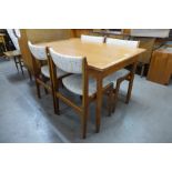 A Danish teak extending dining table and four Eric Buch teak dining chairs
