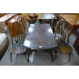 An Ercol dark elm Windsor drop leaf table and four Quaker chairs