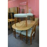 A teak extending dining table and six chairs