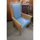 An Art Deco style oak and faux blue leather ecclesiastical chair