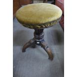 A Victorian mahogany revolving piano stool
