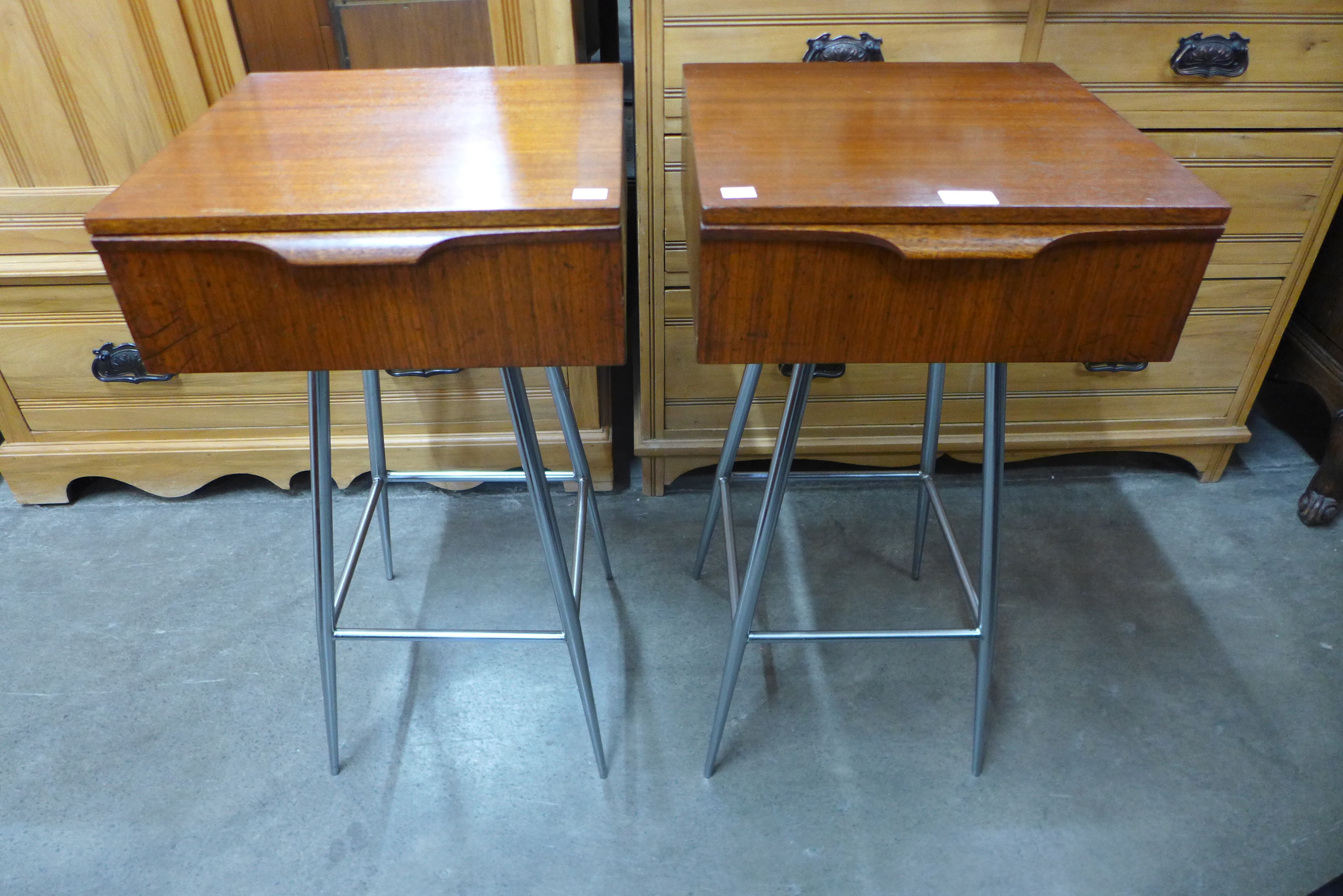 A pair of teak and chrome bedside tables