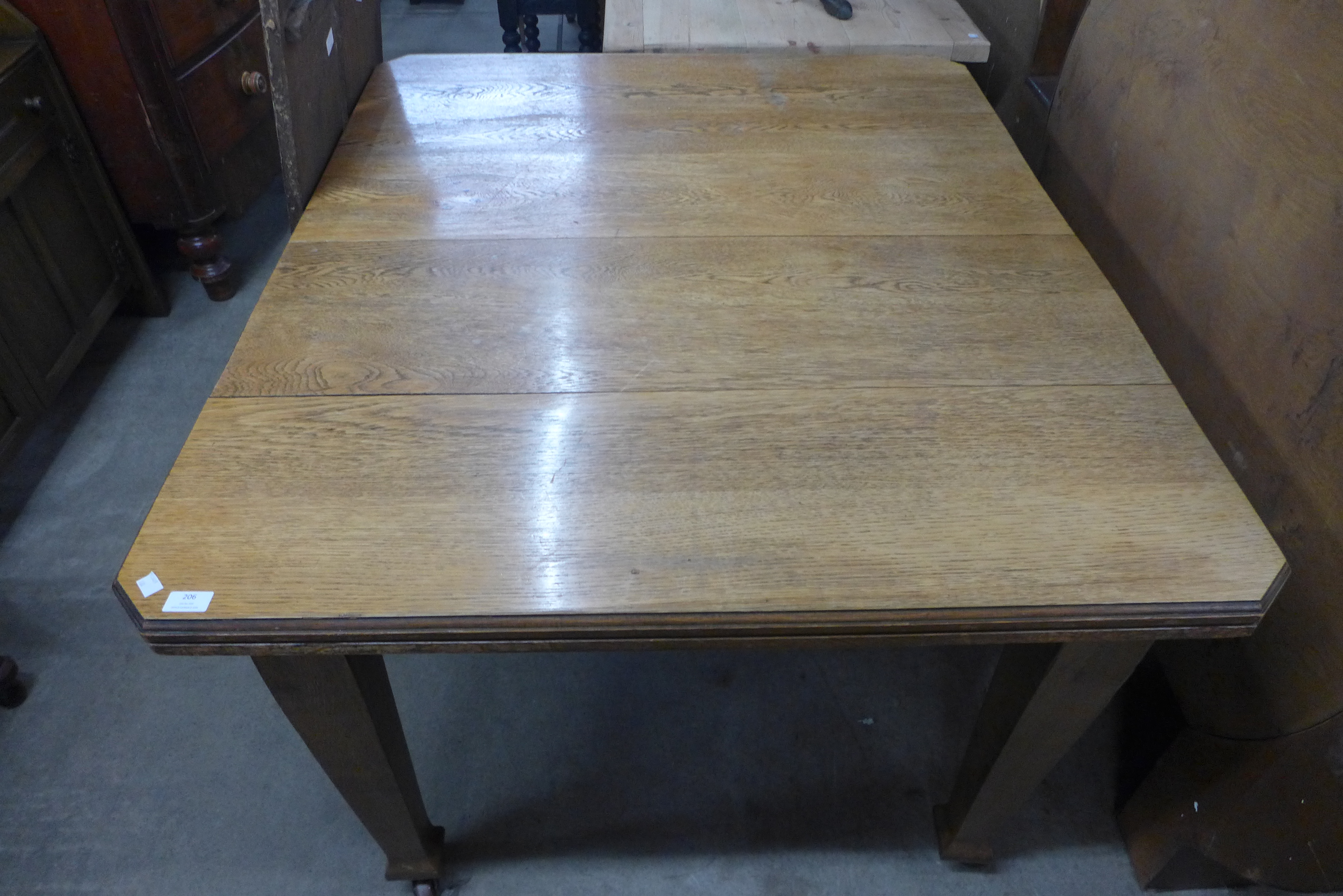 A Victorian oak extending dining table, 74cms h, 106cms w, 123cms l (176 cms l extended) - Image 2 of 2